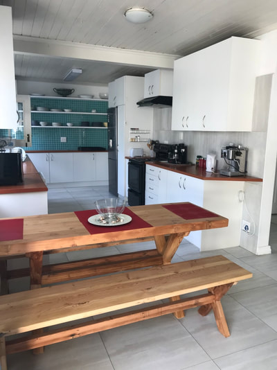 Full kitchen and open plan to dining table